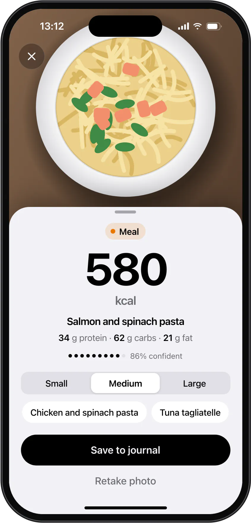 A photo of a plate recognised as salmon and spinach pasta, 580 kcal, ready to save.
